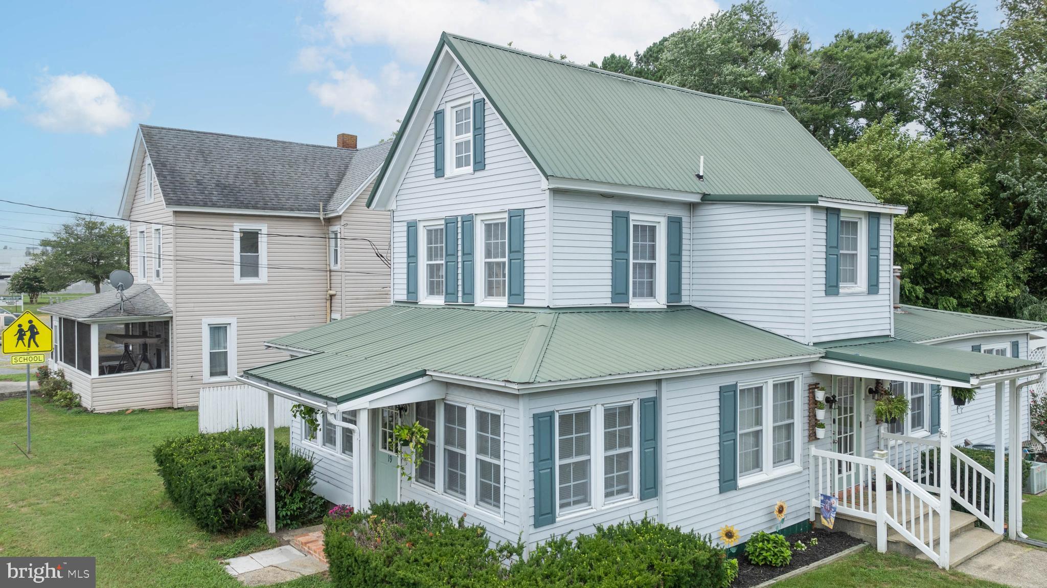 a aerial view of a brick house next to a yard