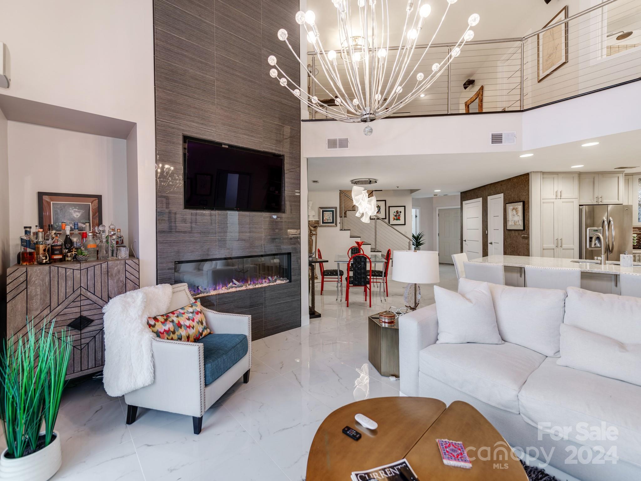 a living room with fireplace furniture and a flat screen tv