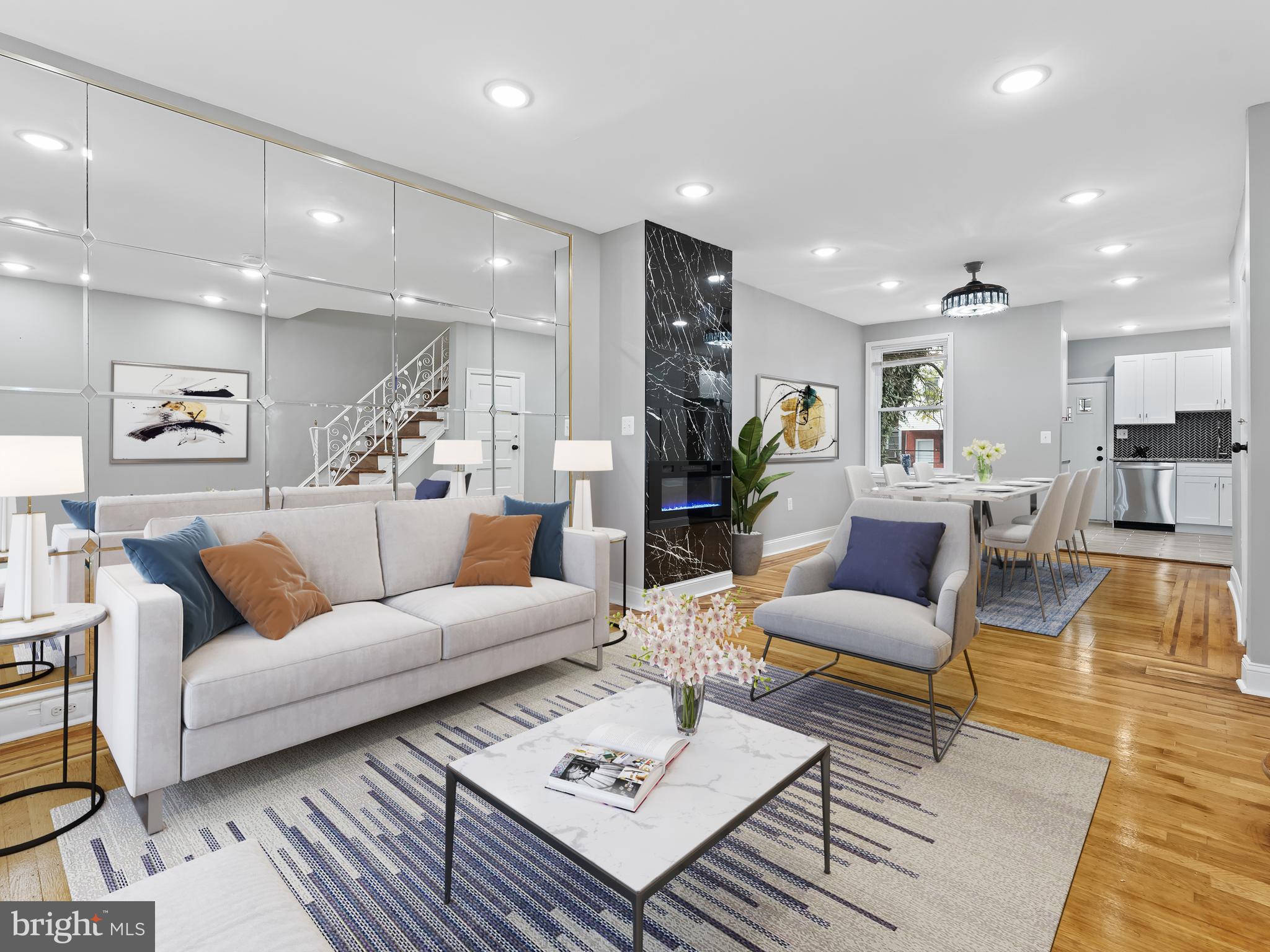 a living room with furniture kitchen view and a table