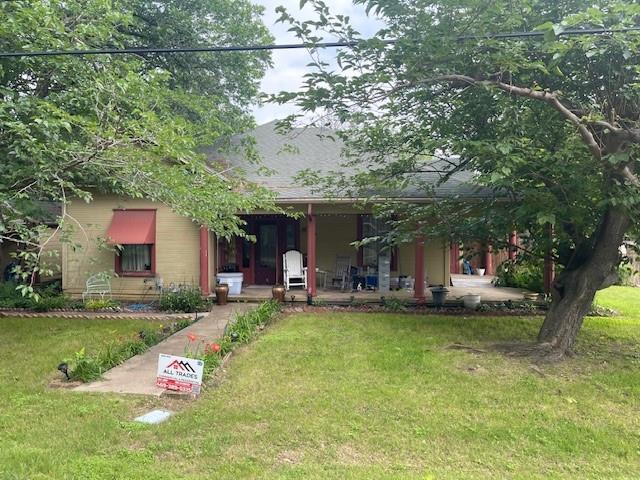 a view of a house with a yard porch and sitting area