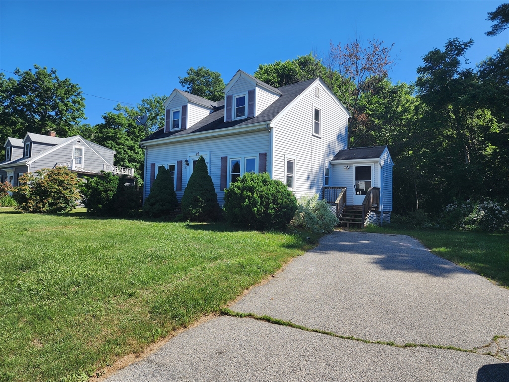 a front view of house with yard and green space