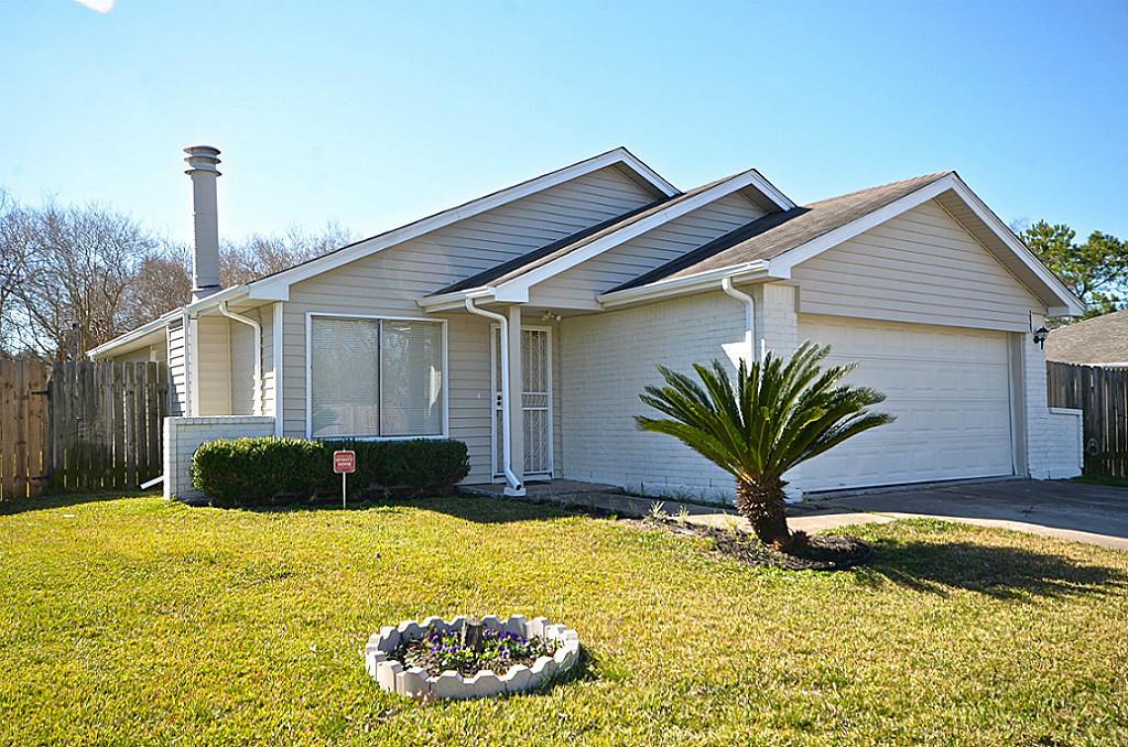 a front view of a house with a garden and yard