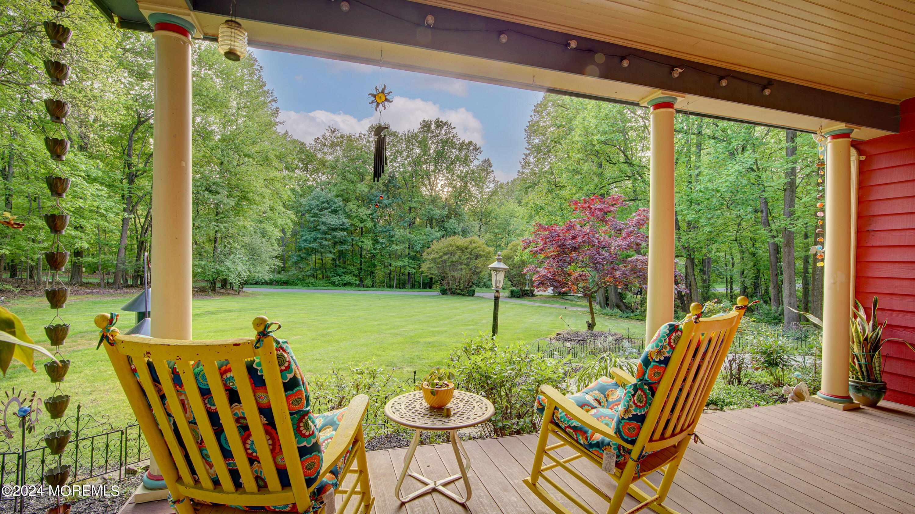 a view of a chairs and table in patio with a backyard