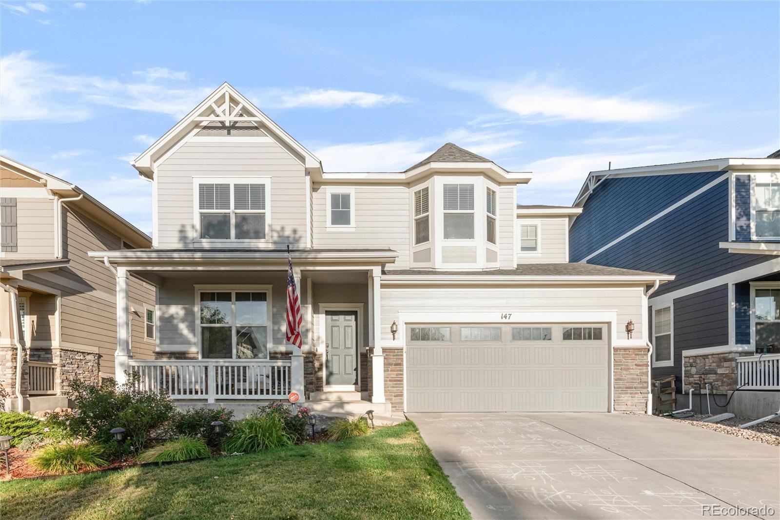 a front view of a house with a yard and garage