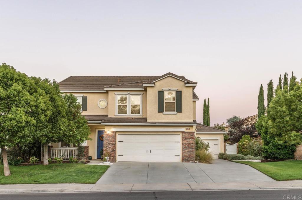 a big house with a small yard and large trees