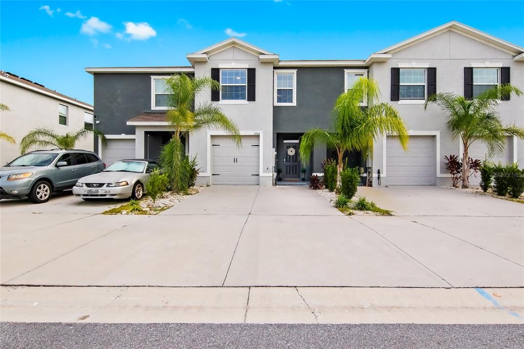 a front view of a house with a yard and garage