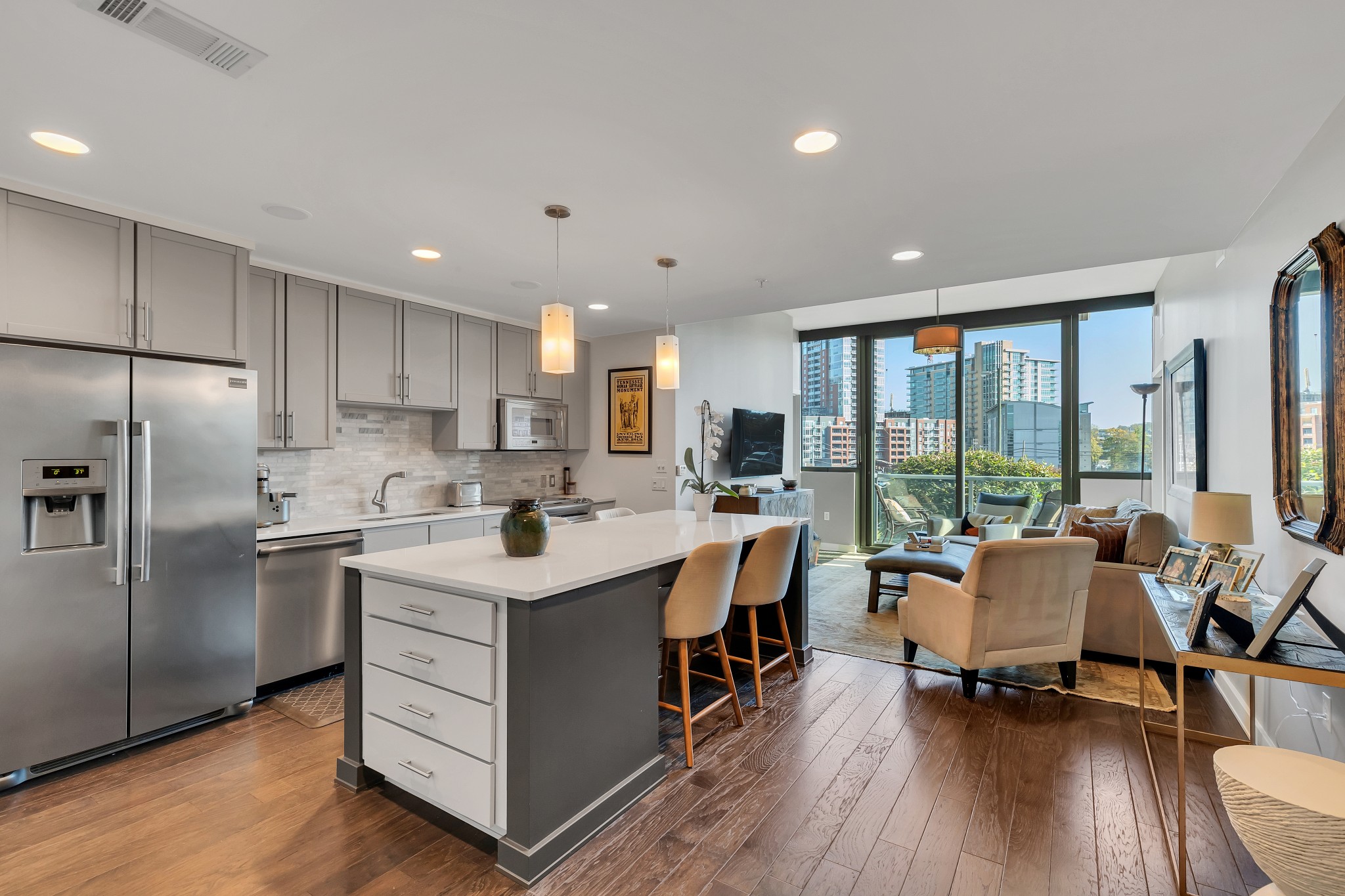 a open kitchen with stainless steel appliances granite countertop a lot of counter space and a large window