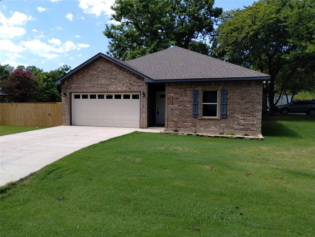 a front view of a house with a garden and yard