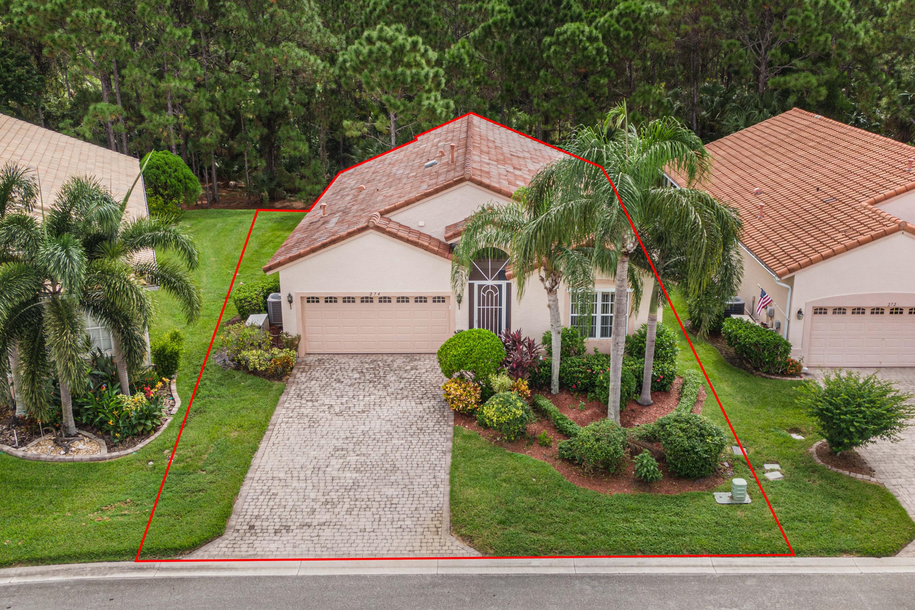 a view of house with garden and tall trees