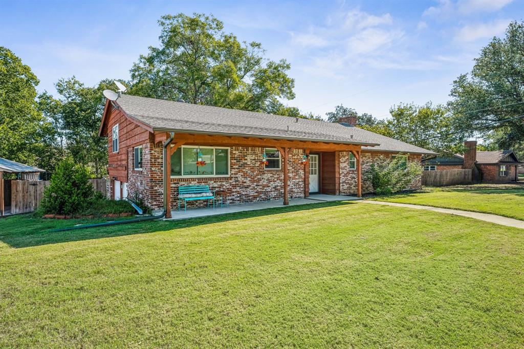 a front view of a house with garden and porch