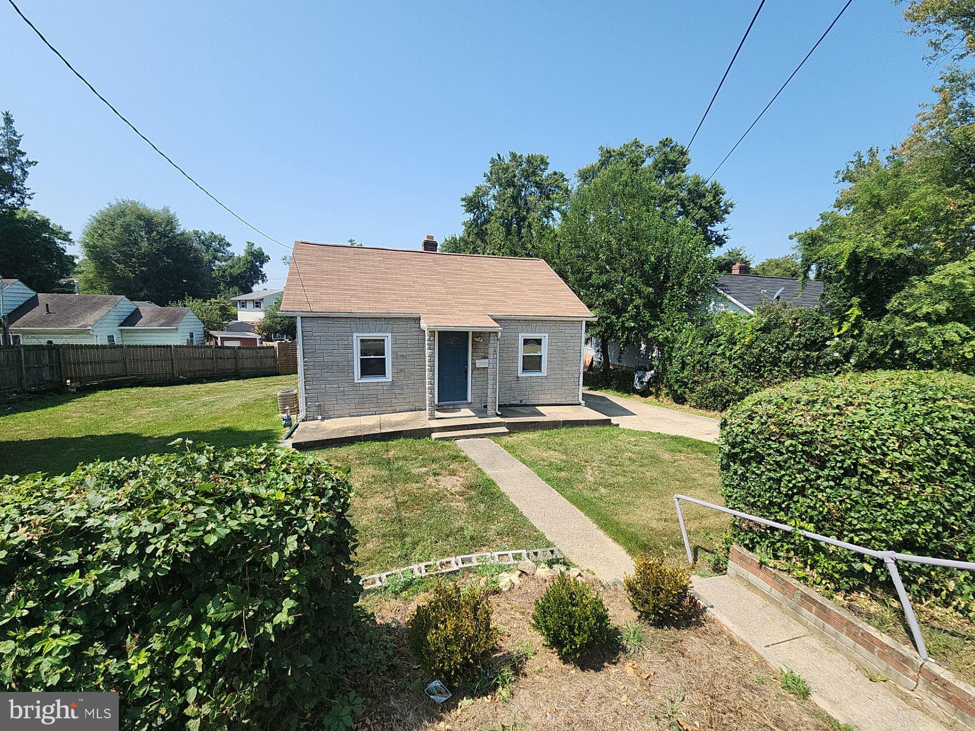 a aerial view of a house with swimming pool and next to a yard