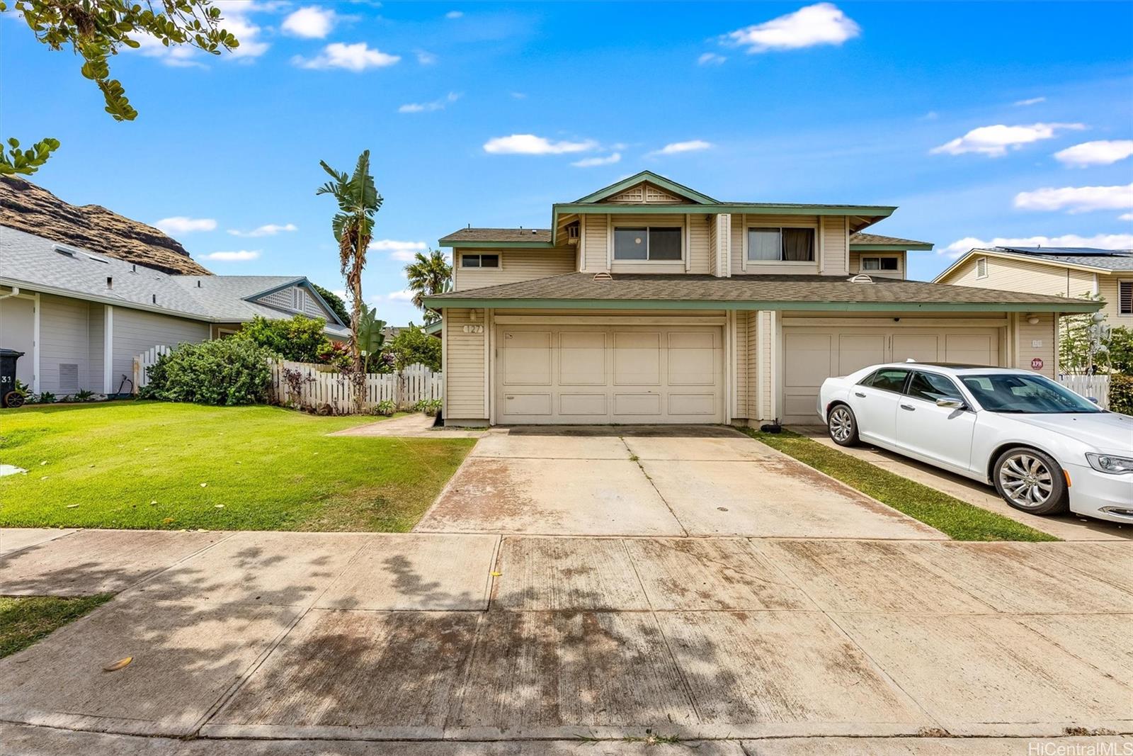 a front view of a house with a yard and garage