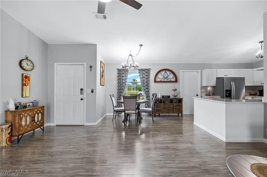 a view of a a dining room hardwood floor and a view of living room