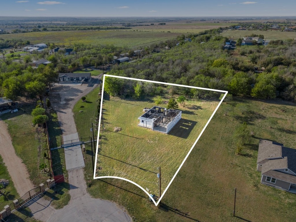 an aerial view of a residential houses with outdoor space