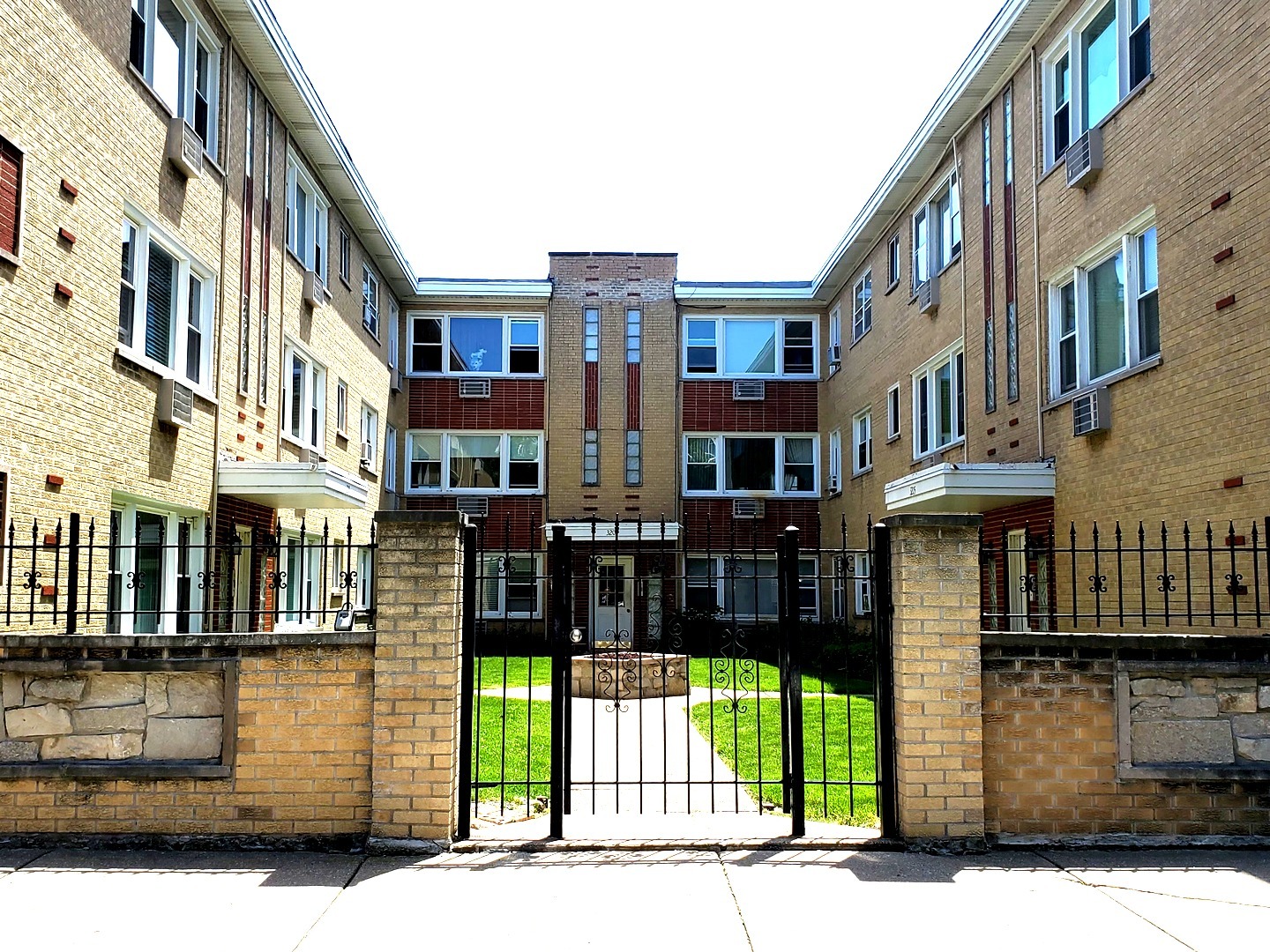 a front view of a building with a garden