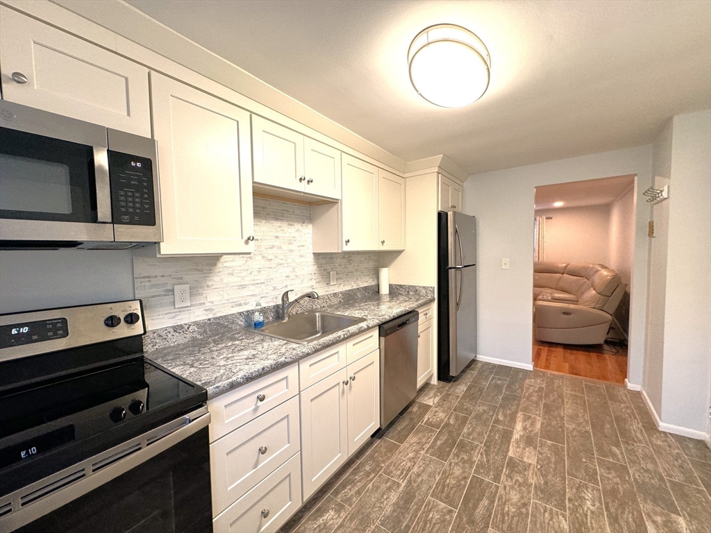 a kitchen with a sink stove and cabinets