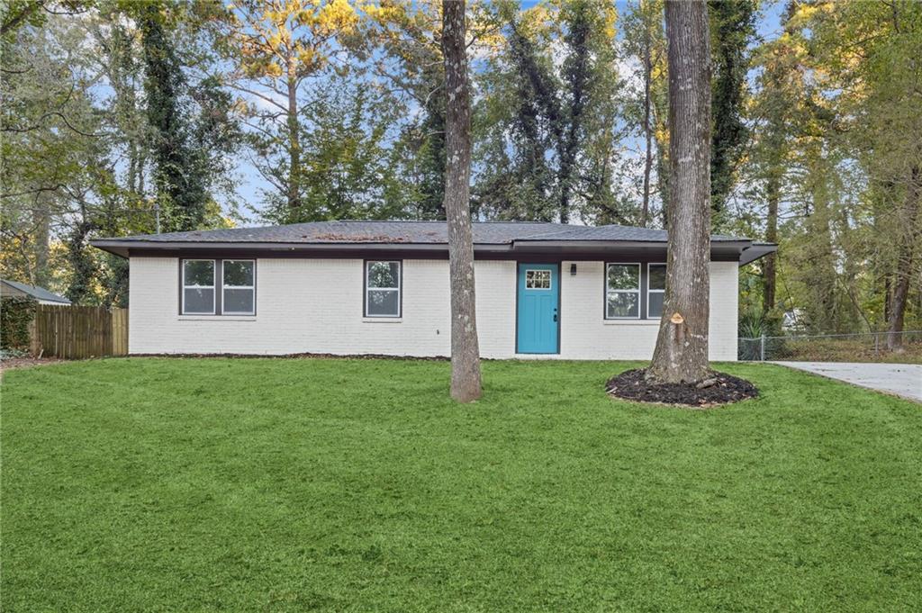 a front view of house with yard and green space