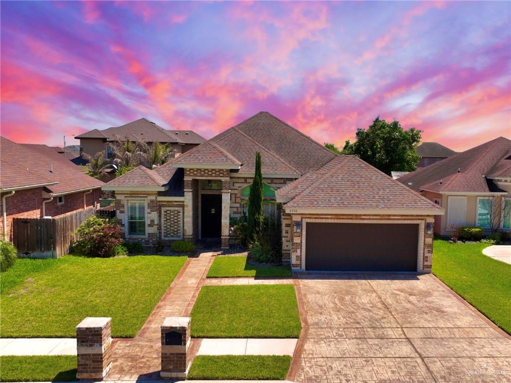 a front view of a house with a yard and garage