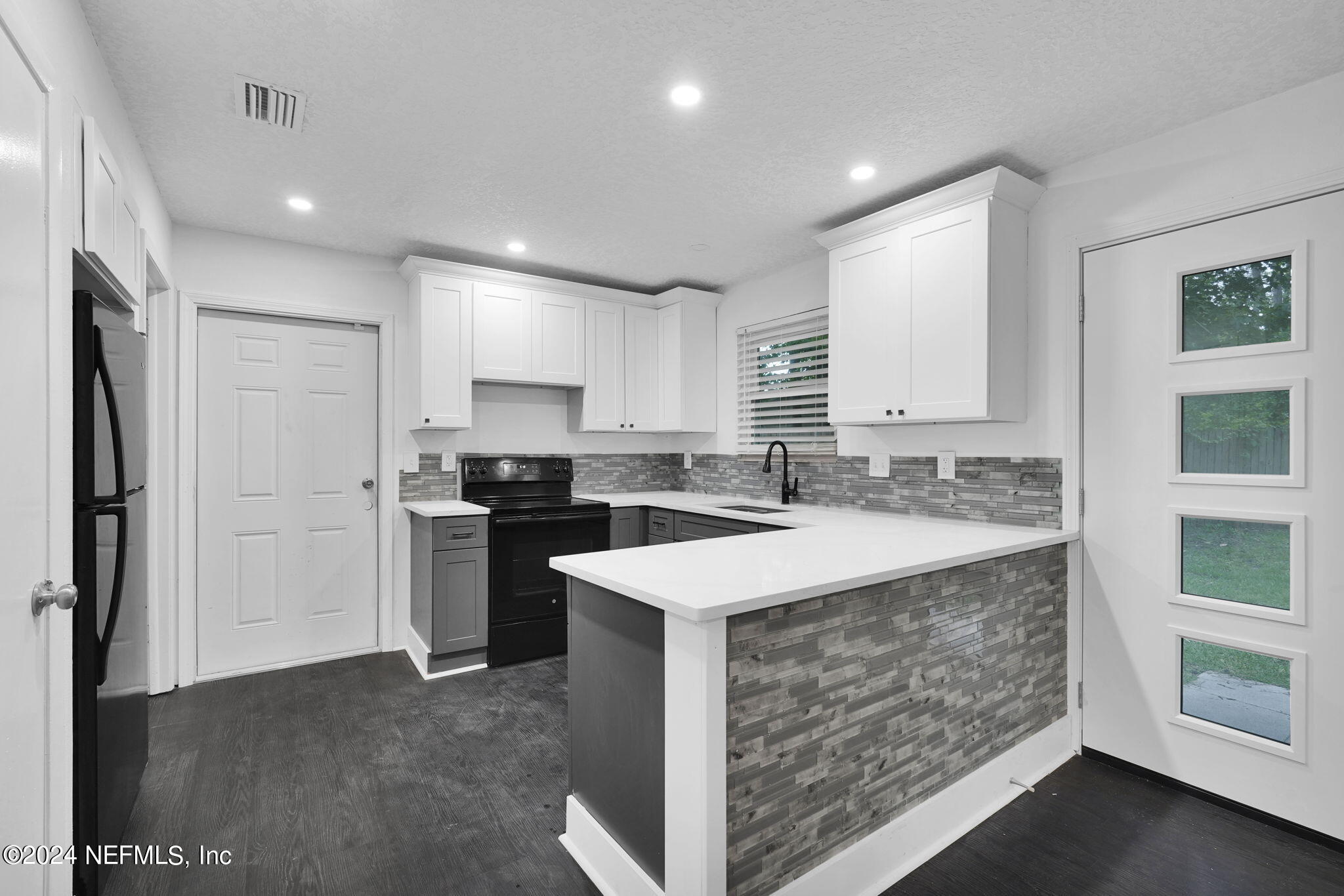 a kitchen with a sink stove and refrigerator