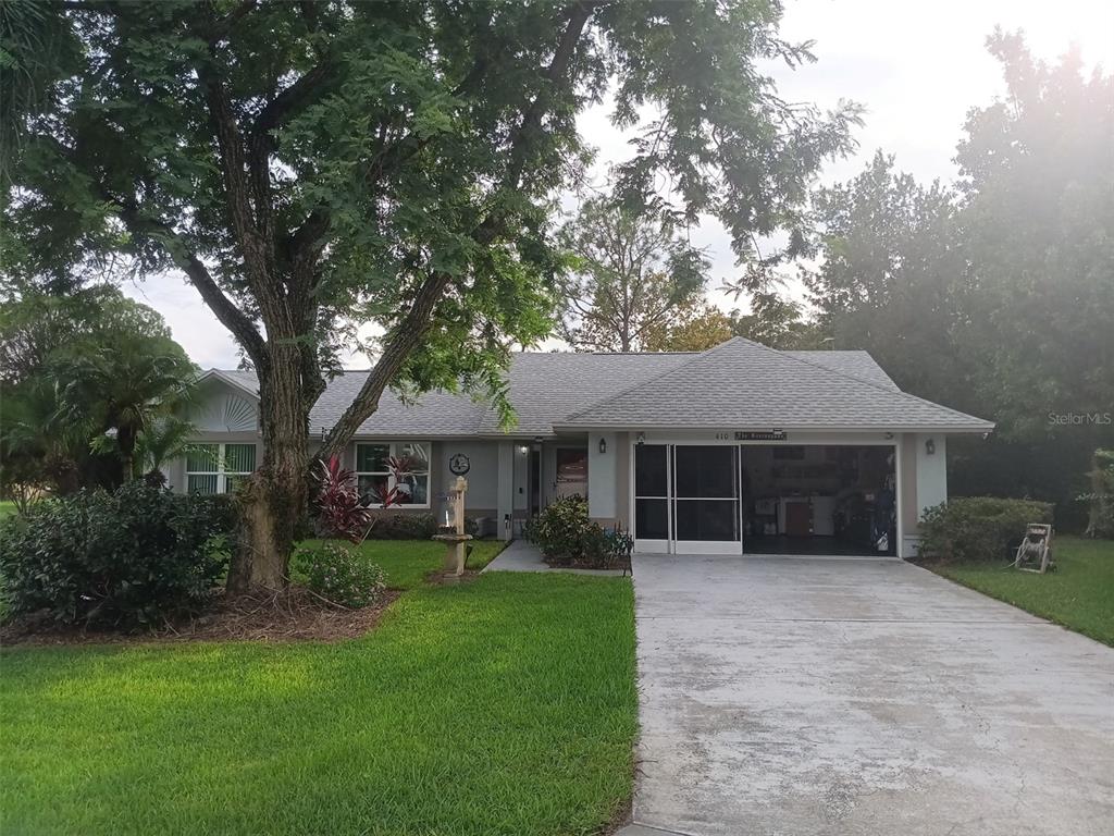 a front view of house with yard and green space