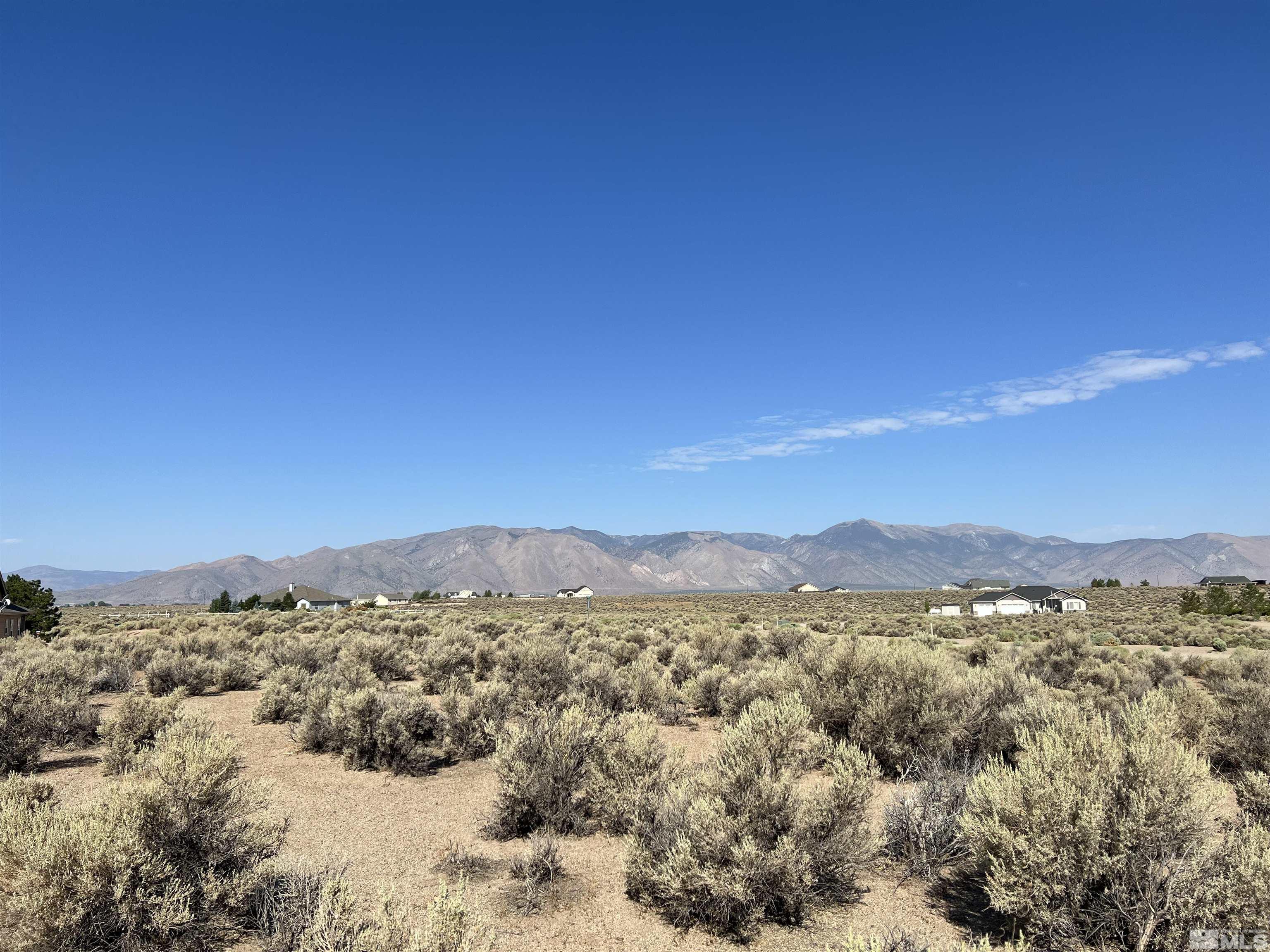 a view of a large mountain with mountains in the background