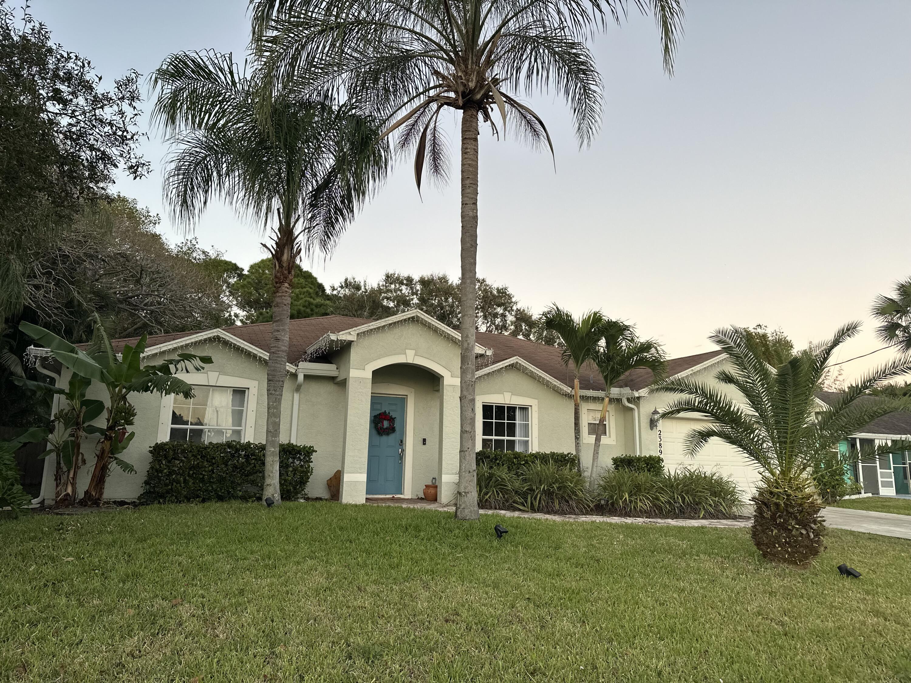 a front view of a house with a garden