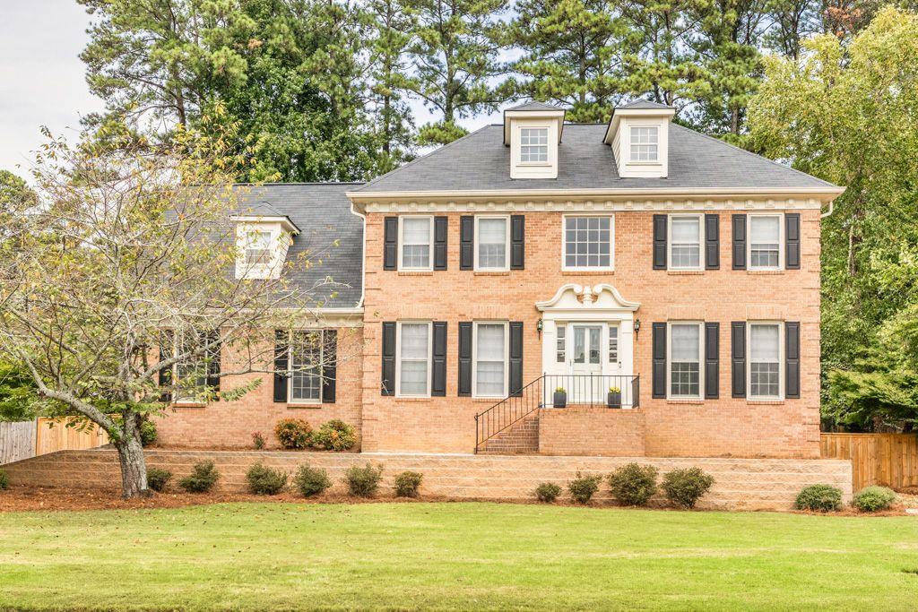 a front view of a house with a yard