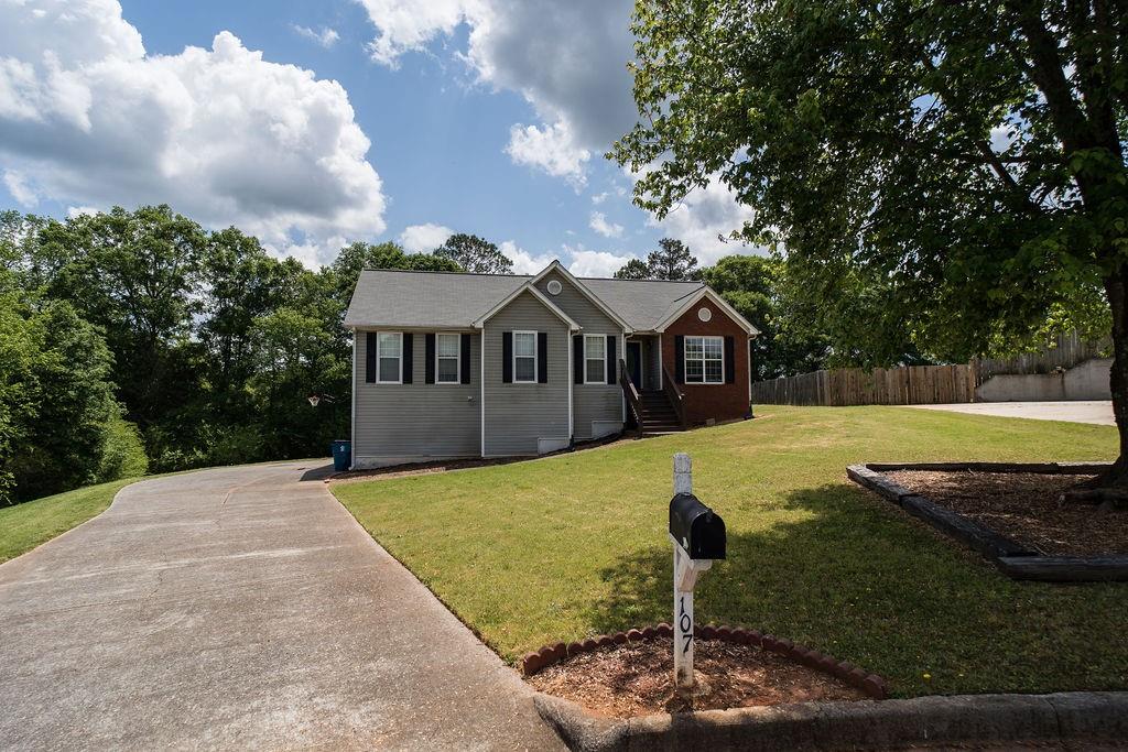 a view of a house with backyard porch and sitting area