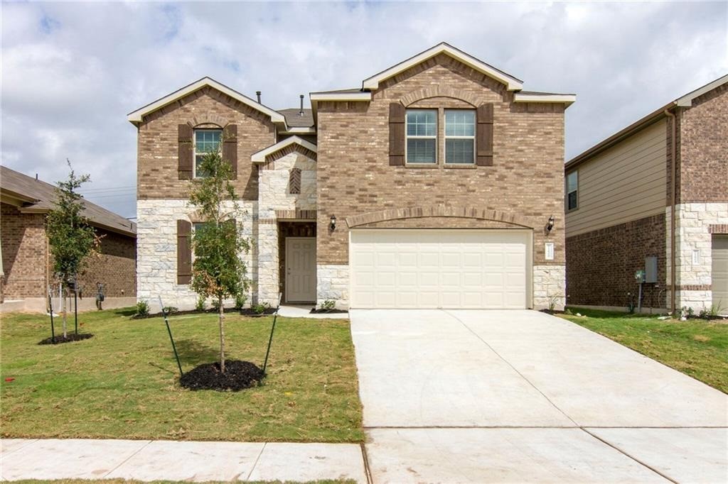 a front view of a house with a yard