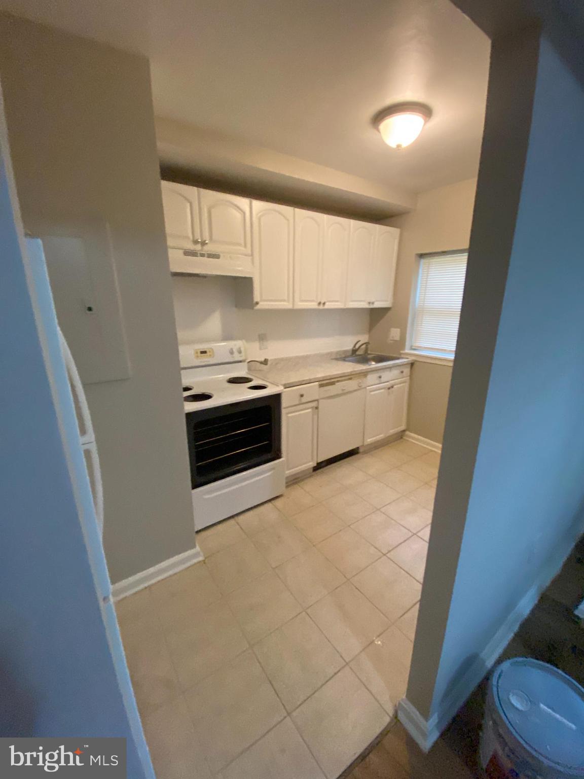 a kitchen with stainless steel appliances a stove a sink and a refrigerator