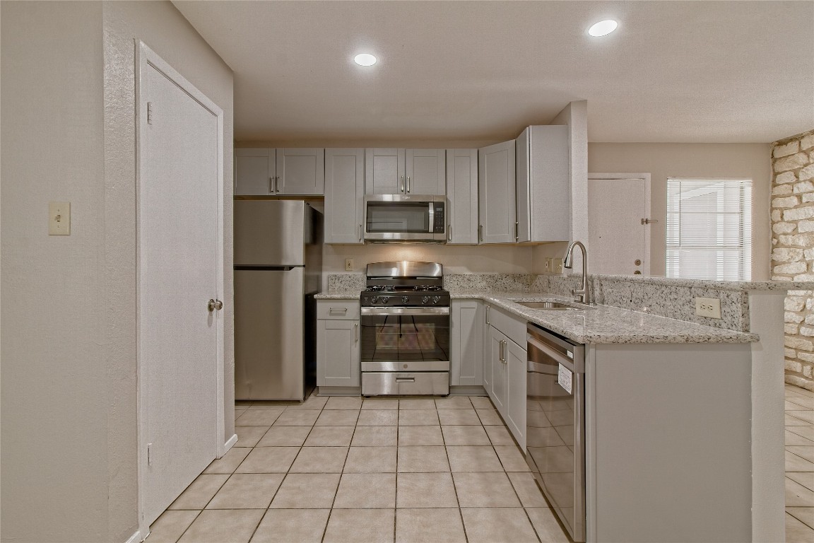 a kitchen with a stove a sink and a refrigerator