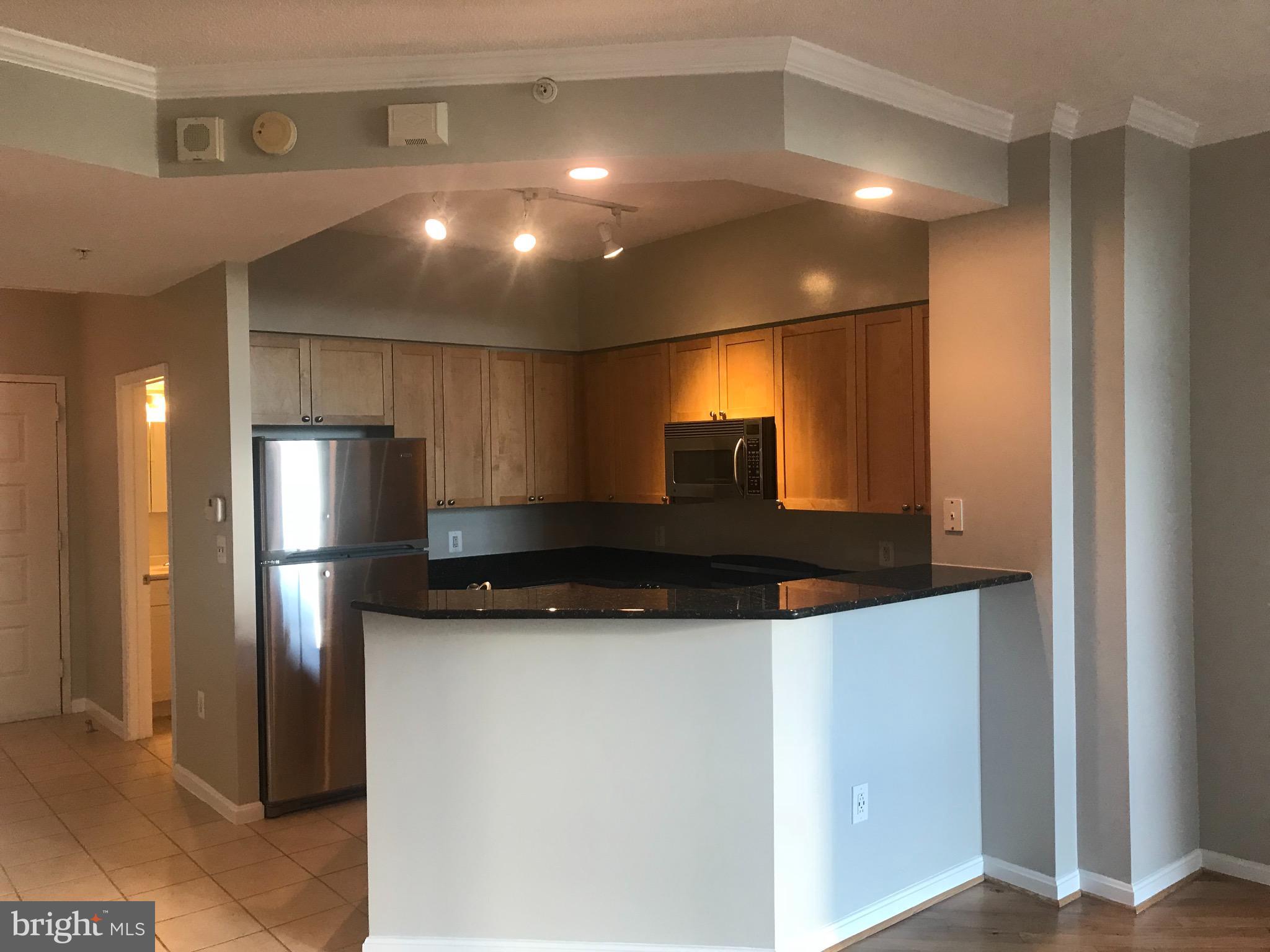 a kitchen with stainless steel appliances a refrigerator and a stove