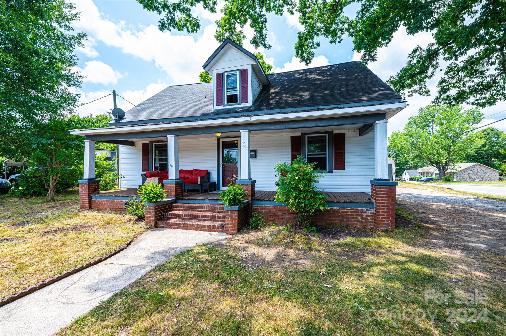 a front view of a house with garden