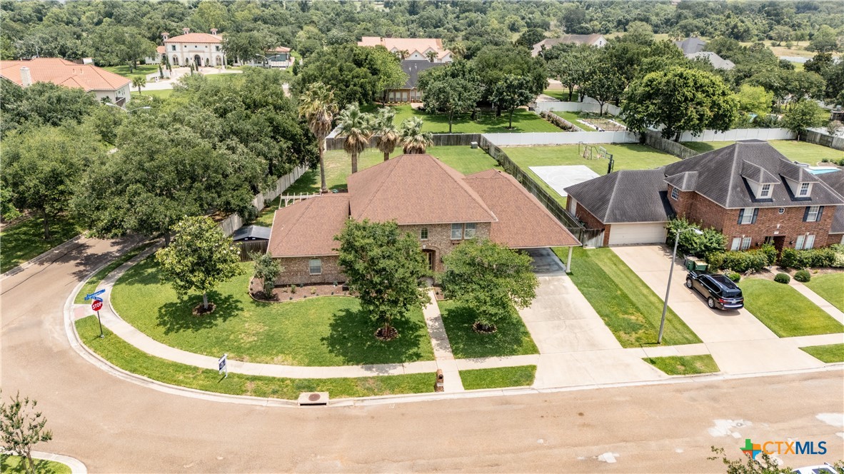 an aerial view of a house with a swimming pool