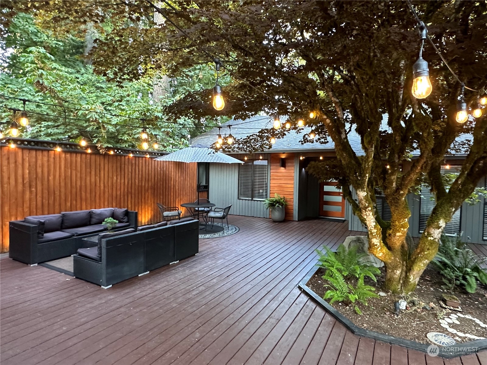 a view of a couches in the patio and a small yard