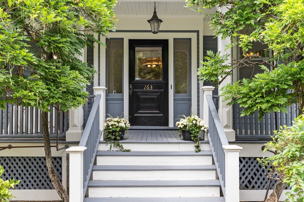 a front view of a house with a potted plant