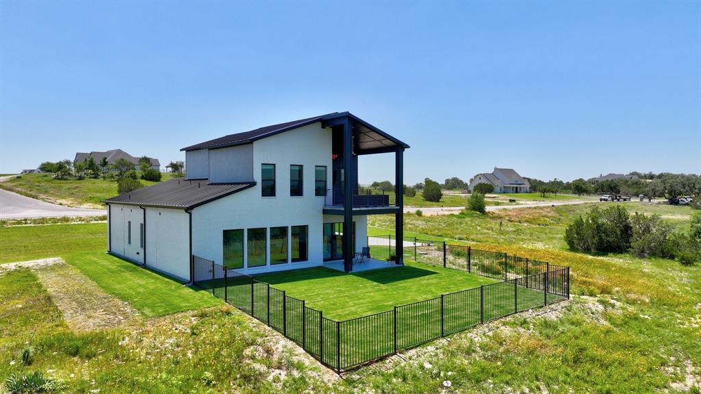 a view of a house with pool and a yard