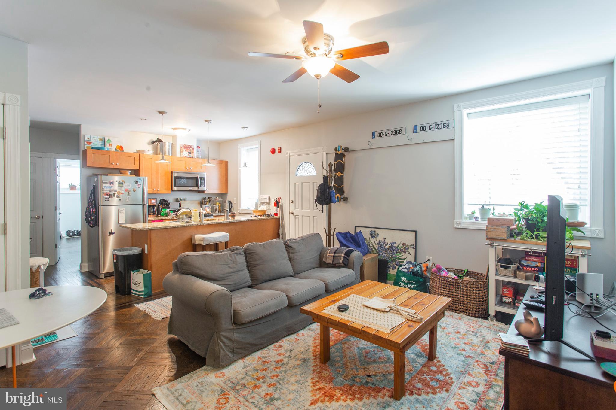 a living room with furniture a rug and a window