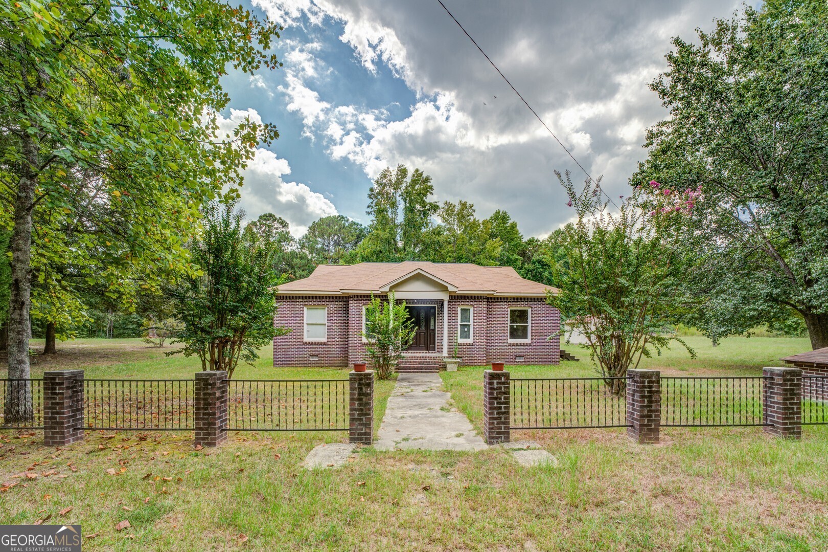 a front view of a house with garden