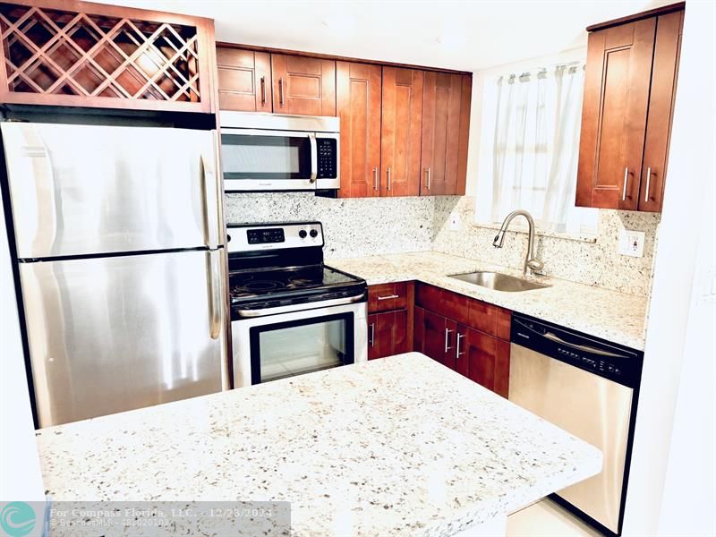 a kitchen with a refrigerator stove and sink