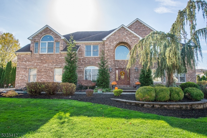 a front view of a house with a garden and plants