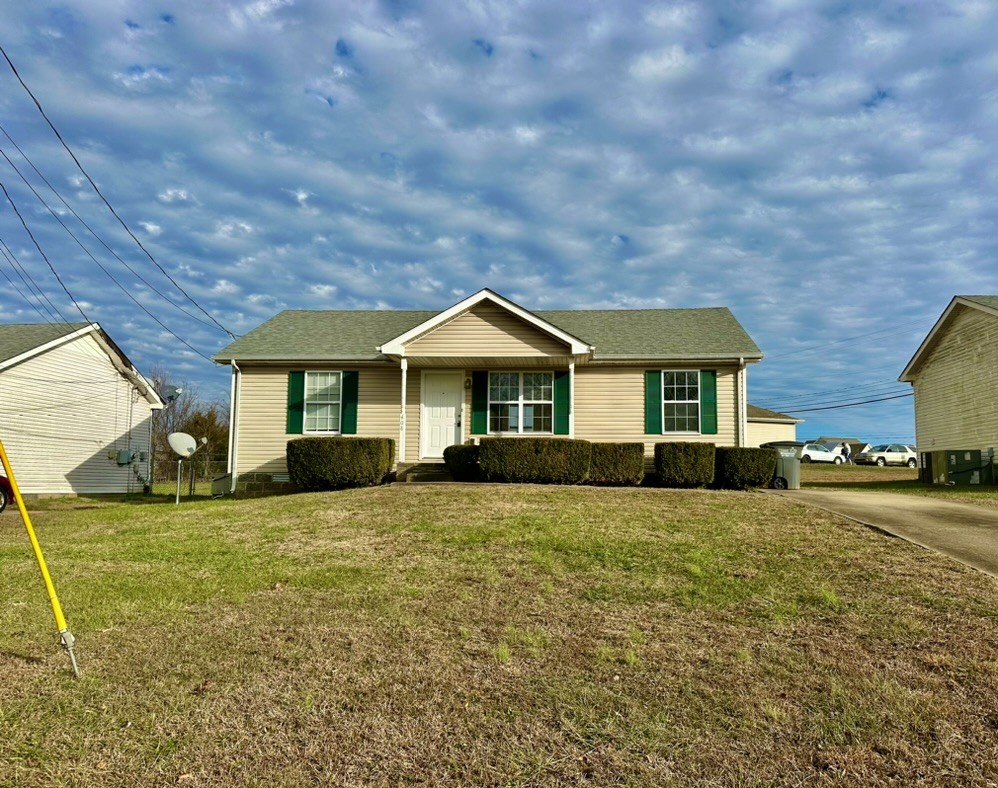 a front door view of a house with yard