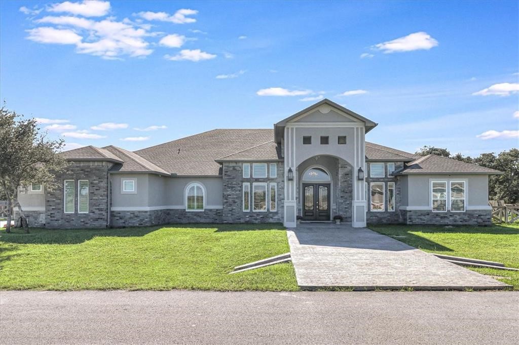 a front view of a house with a yard and garage