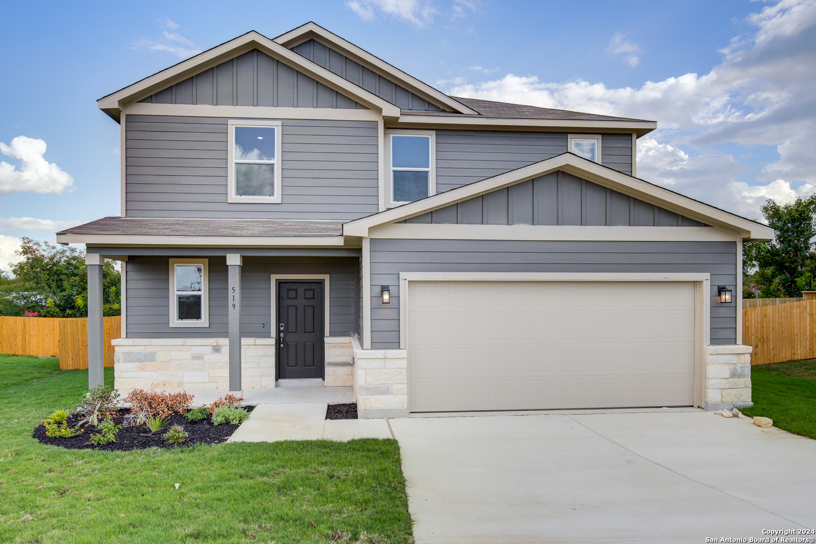 a front view of a house with a yard and garage