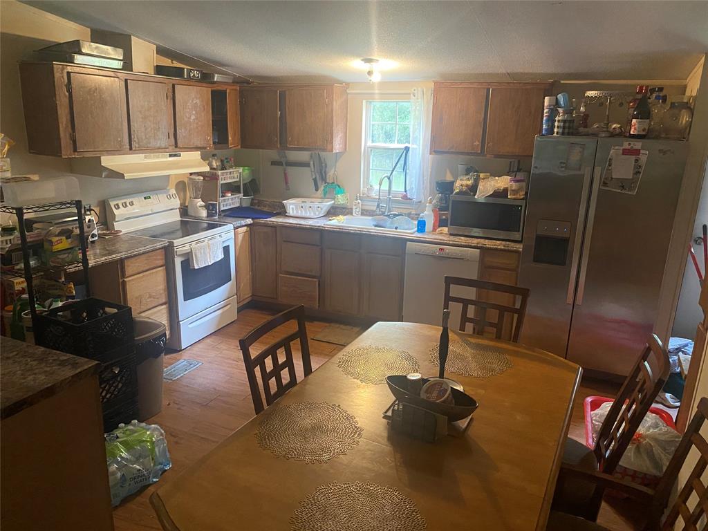 a kitchen with a sink appliances and cabinets