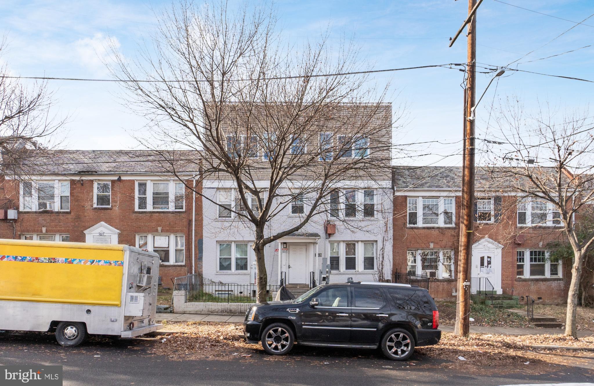 a car parked in front of a brick house