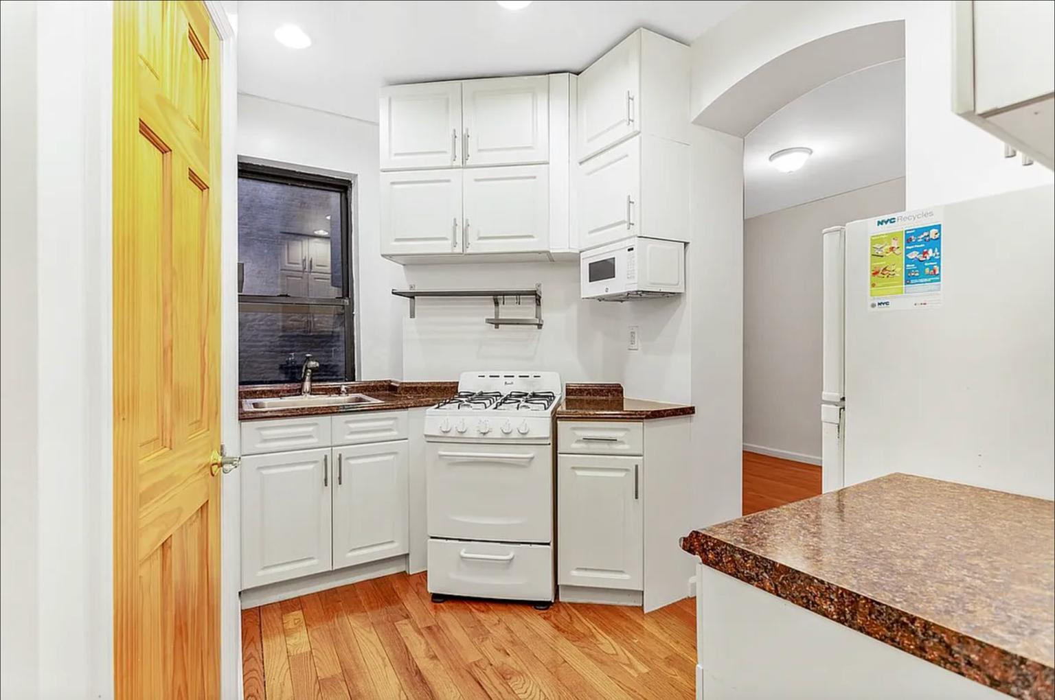 a kitchen with stainless steel appliances granite countertop a sink and cabinets