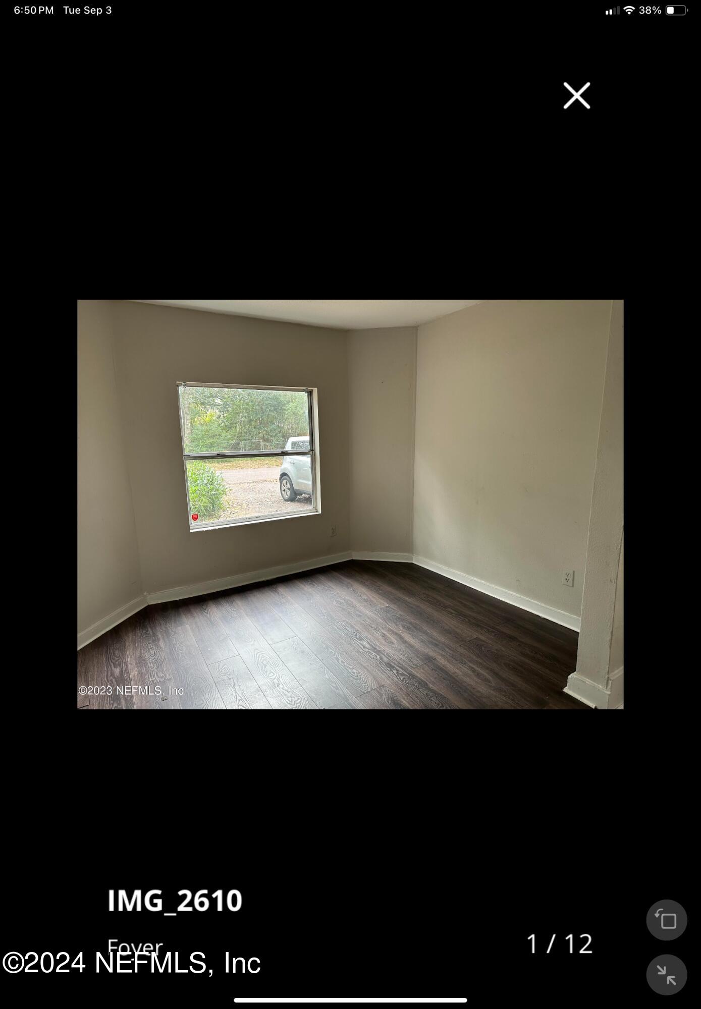 a view of an empty room with a window