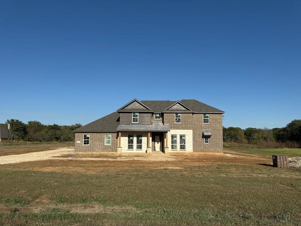 a front view of a house with a yard