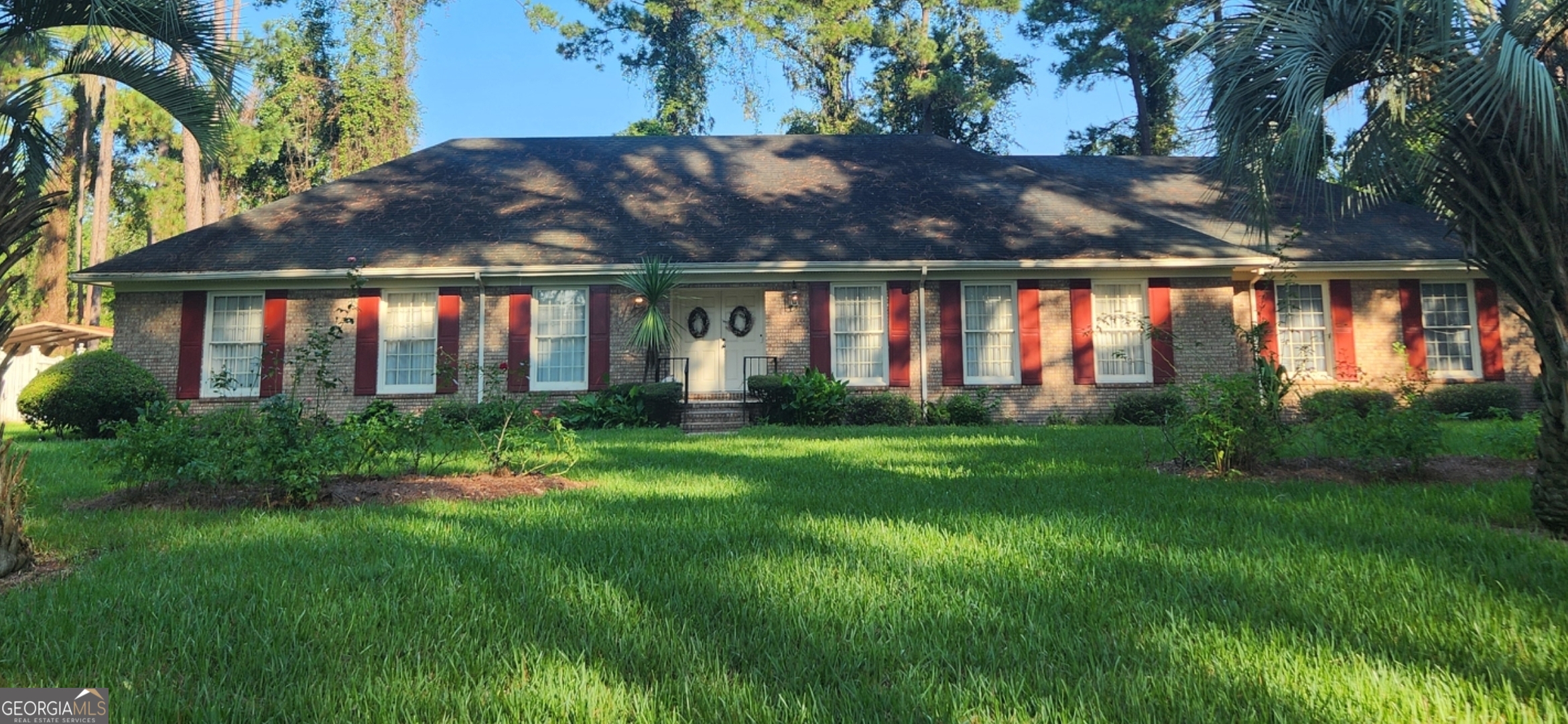 a front view of house with yard and outdoor seating